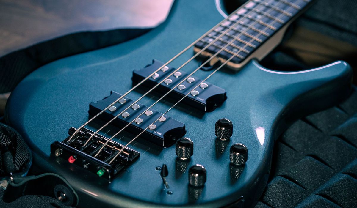 Blue electric bass with active controls