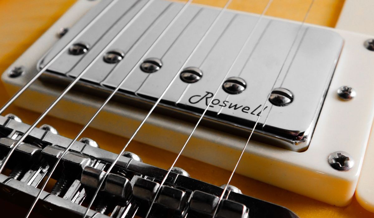 Electric guitar bridge and humbucker pickup close-up