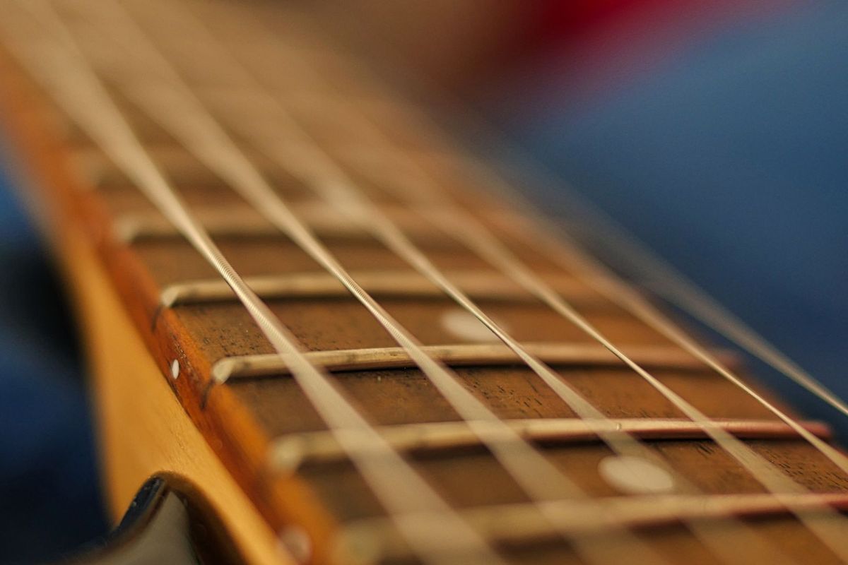 Extreme close-up of electric guitar frets and strings