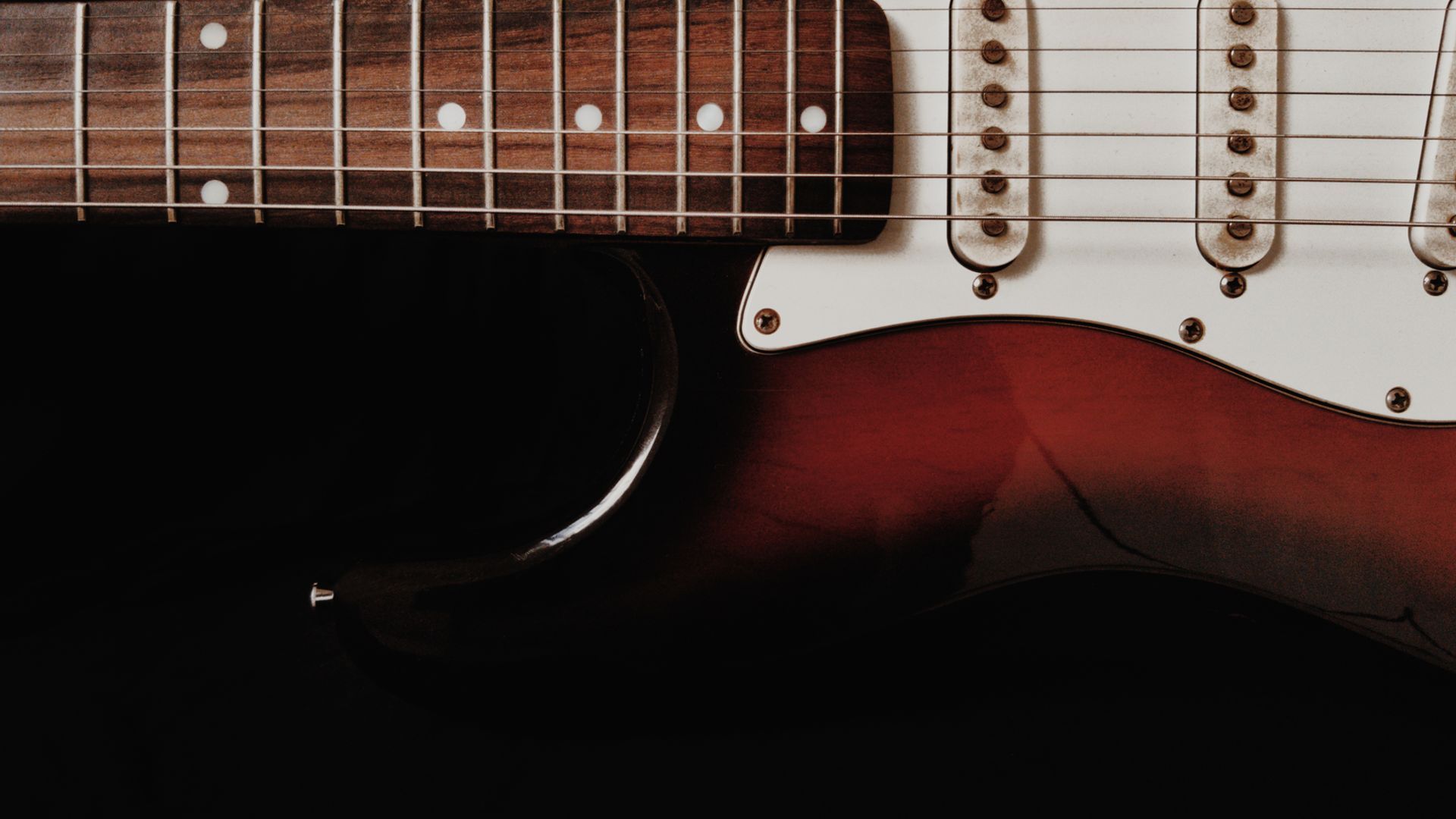 Close-up of an electric guitar body and pickups