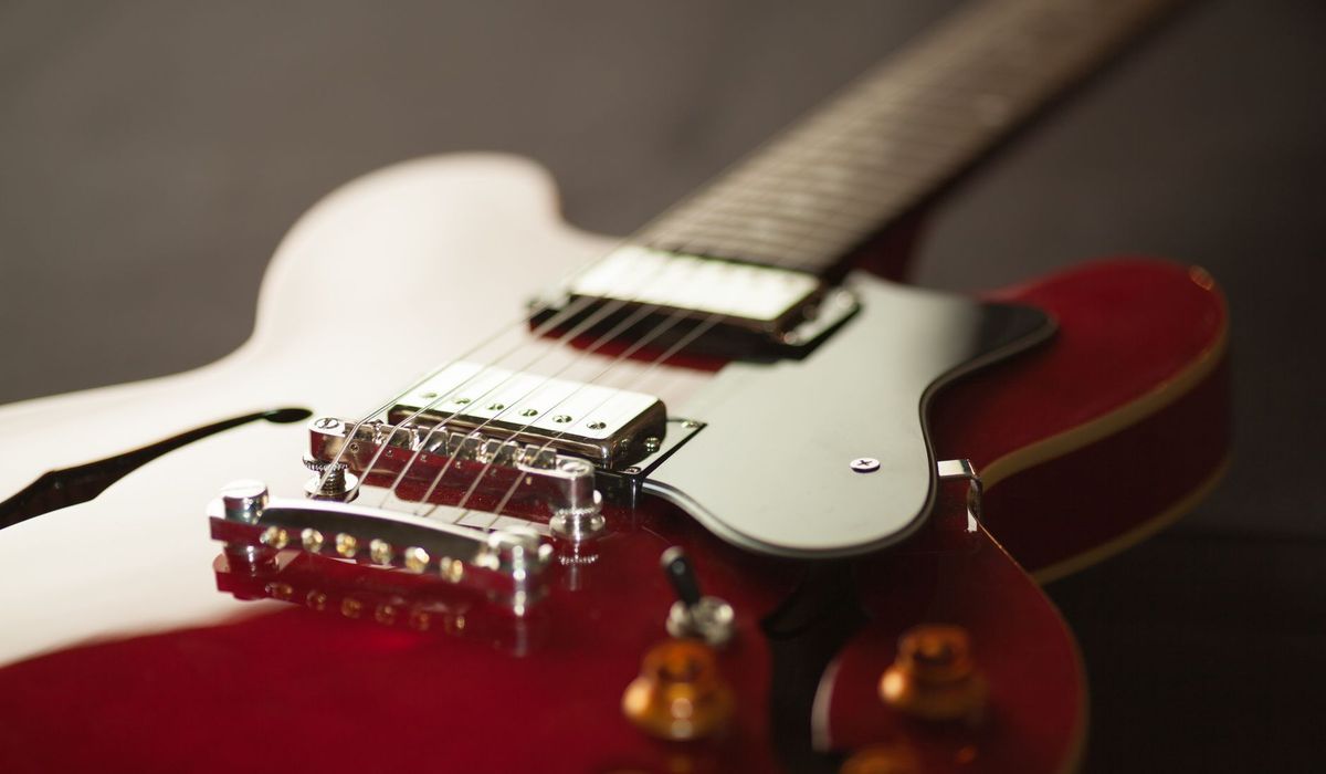 Red electric guitar body with bridge and pickups